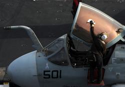 ARABIAN SEA (July 11, 2012) A plane captain, assigned to the Lancers of Electronic Attack Squadron (VAQ) 131, wipes down the canopy of an EA-6B Prowler on the flight deck of the Nimitz-class aircraft carrier USS Abraham Lincoln (CVN 72). Lincoln is deployed to the U.S. 5th Fleet area of responsibility conducting maritime security operations and theater security cooperation efforts. (U.S. Navy photo by Mass Communication Specialist 2nd Class Jonathan P. Idle/Released)